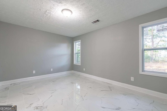 spare room featuring a textured ceiling