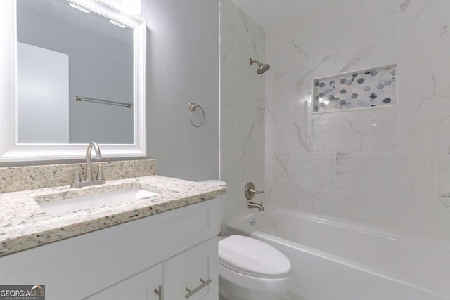 full bathroom featuring vanity, tiled shower / bath combo, and toilet