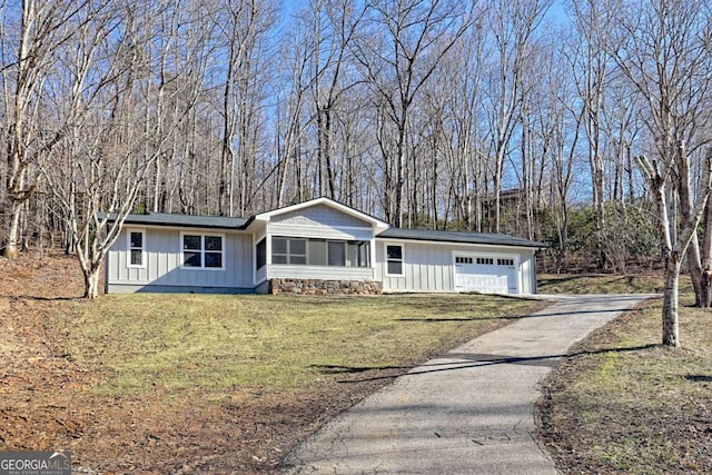 single story home with a garage and a front yard