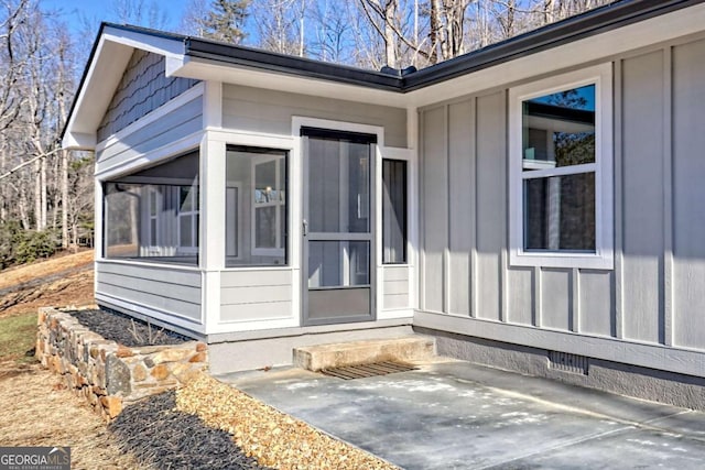 view of exterior entry featuring a patio