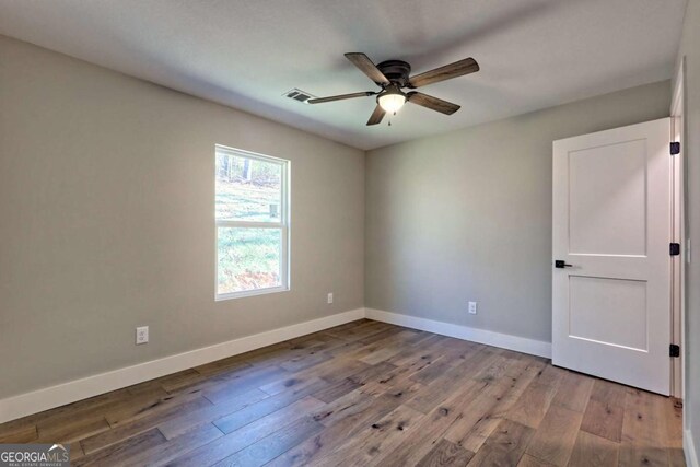 unfurnished room with ceiling fan and light wood-type flooring