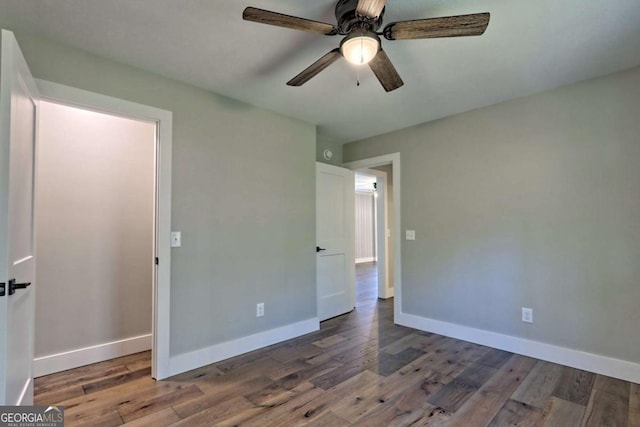 unfurnished bedroom with dark wood-type flooring and ceiling fan