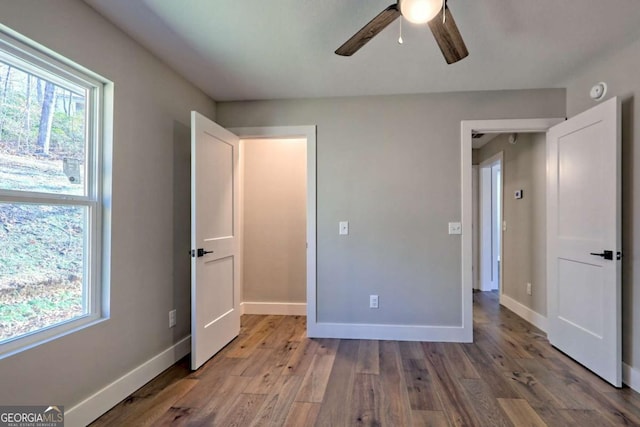 unfurnished bedroom with hardwood / wood-style floors and ceiling fan