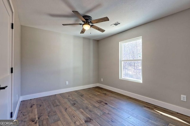 empty room with hardwood / wood-style flooring and ceiling fan