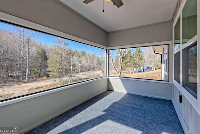 unfurnished sunroom with vaulted ceiling, plenty of natural light, and ceiling fan