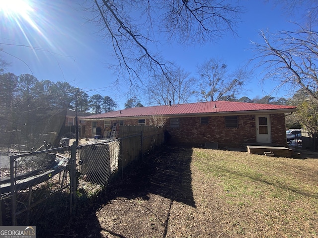 back of property featuring a lawn