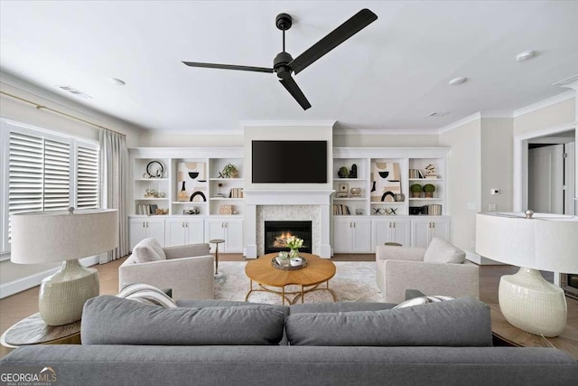 living room featuring crown molding, light hardwood / wood-style flooring, and ceiling fan