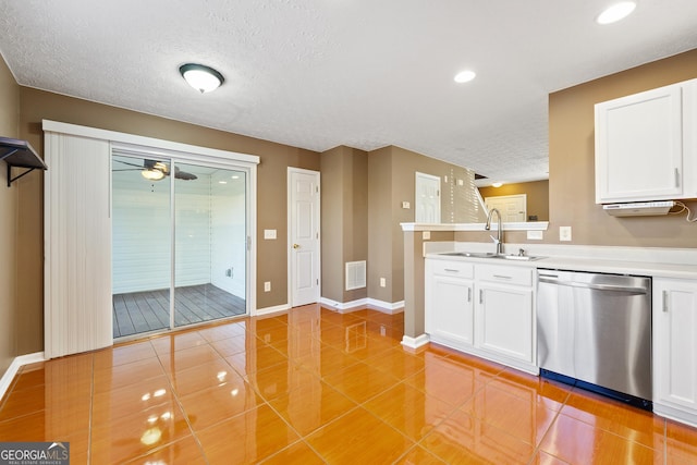 kitchen featuring dishwasher, sink, white cabinets, and a textured ceiling