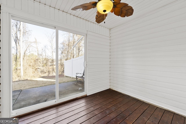 unfurnished sunroom featuring ceiling fan