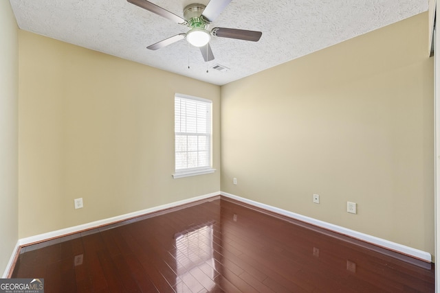 spare room with ceiling fan, hardwood / wood-style flooring, and a textured ceiling