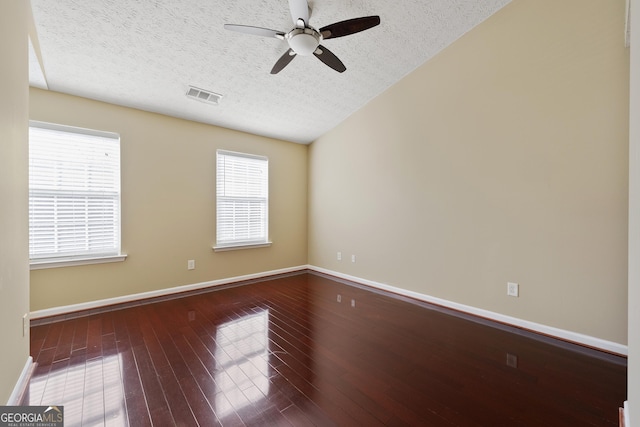 spare room with hardwood / wood-style floors, a textured ceiling, and ceiling fan