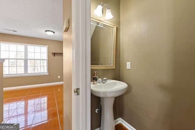 bathroom with sink, tile patterned floors, and a textured ceiling