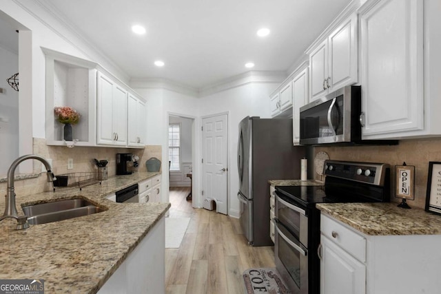 kitchen featuring sink, crown molding, light wood-type flooring, appliances with stainless steel finishes, and white cabinets