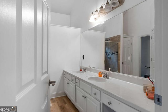 bathroom featuring vanity, hardwood / wood-style floors, and walk in shower