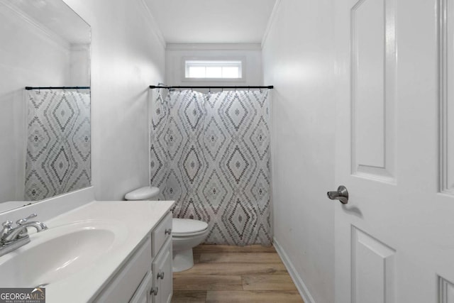 bathroom with toilet, crown molding, vanity, a shower with shower curtain, and hardwood / wood-style flooring