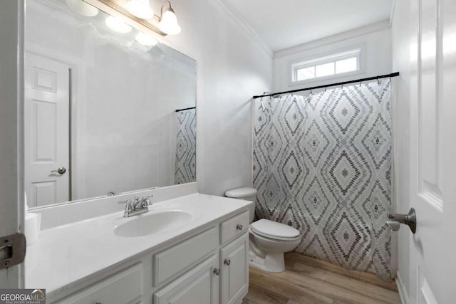 bathroom with toilet, crown molding, a shower with curtain, vanity, and hardwood / wood-style flooring