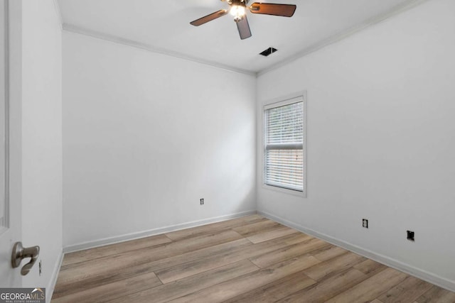 spare room featuring ceiling fan, ornamental molding, and light wood-type flooring