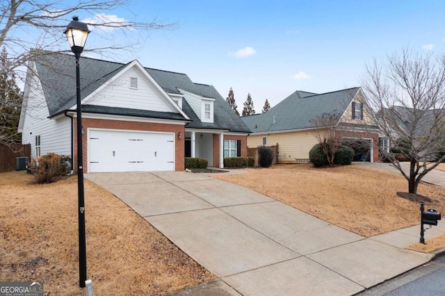 view of front of property with a garage and cooling unit