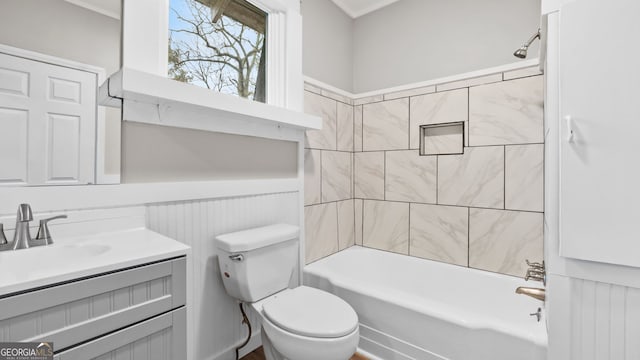 full bathroom featuring vanity, toilet, and tiled shower / bath combo