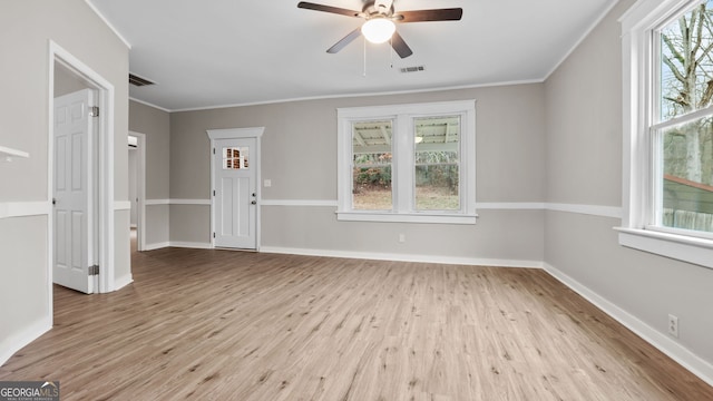 empty room with crown molding, ceiling fan, and light hardwood / wood-style floors