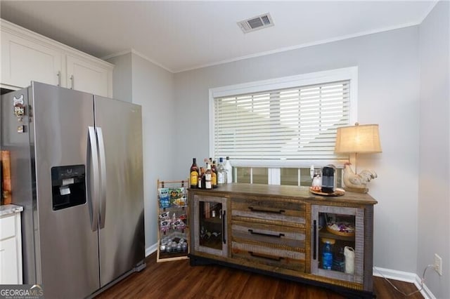 kitchen featuring white cabinetry, stainless steel refrigerator with ice dispenser, dark hardwood / wood-style floors, and crown molding