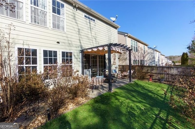 back of property featuring a yard, a pergola, and a patio area