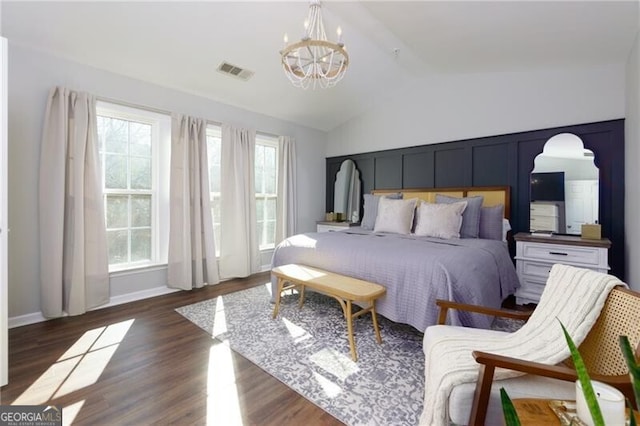 bedroom with lofted ceiling, dark hardwood / wood-style floors, and a chandelier