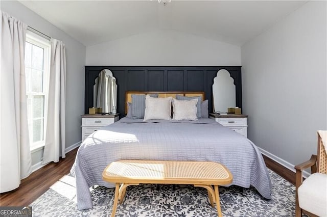 bedroom with vaulted ceiling and wood-type flooring