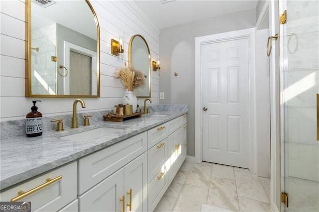 bathroom with vanity and a shower with shower door