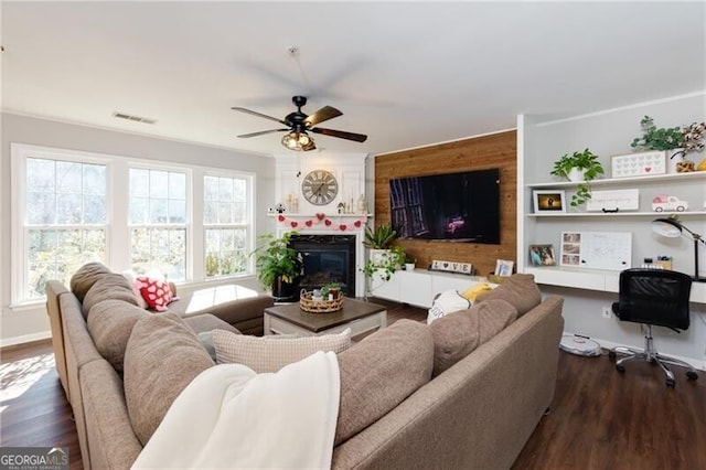 living room featuring ceiling fan and dark hardwood / wood-style flooring