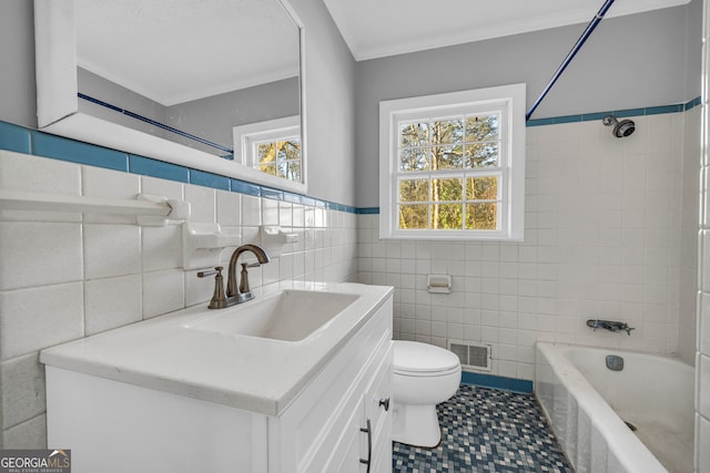 bathroom featuring tile walls, crown molding, toilet, and a healthy amount of sunlight