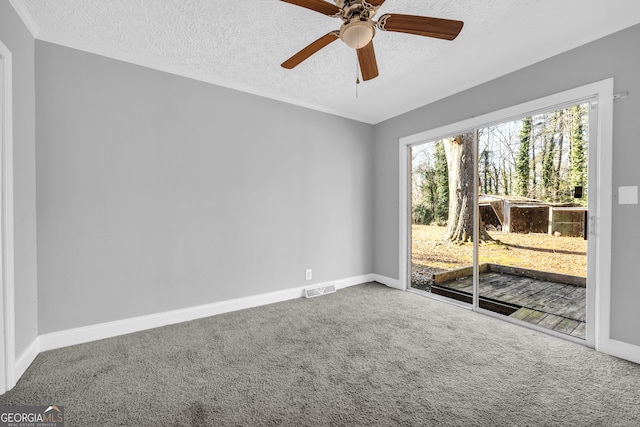 carpeted spare room with ceiling fan and a textured ceiling