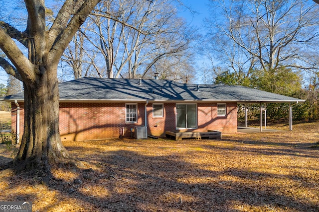 view of front of home featuring a carport and cooling unit