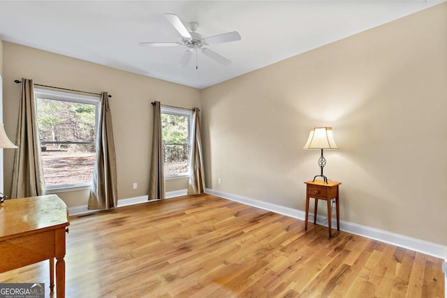 unfurnished room with ceiling fan and light wood-type flooring