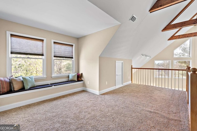 bonus room with vaulted ceiling with beams and carpet flooring