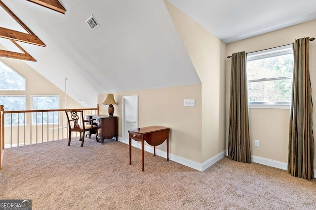 additional living space featuring vaulted ceiling with beams and light colored carpet