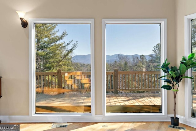 entryway with a mountain view and light hardwood / wood-style flooring