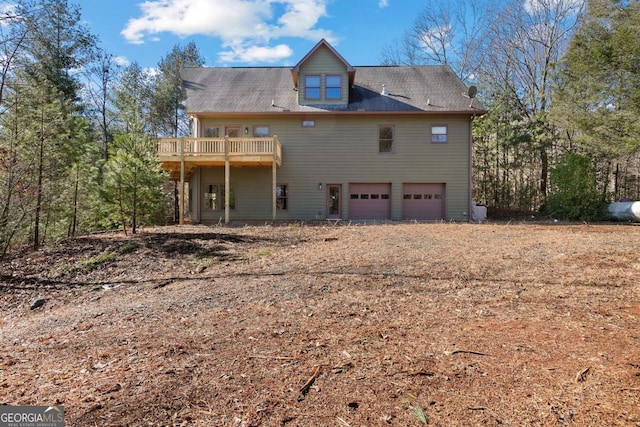 rear view of property with a garage