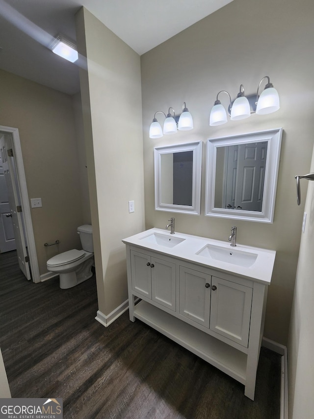 bathroom featuring vanity, toilet, and hardwood / wood-style floors