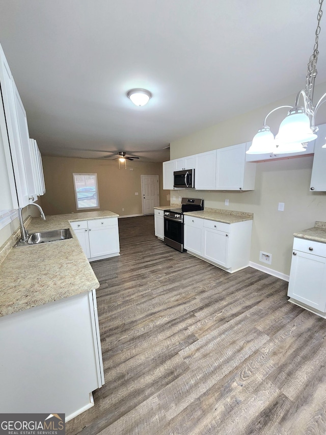 kitchen featuring pendant lighting, white cabinetry, appliances with stainless steel finishes, and sink