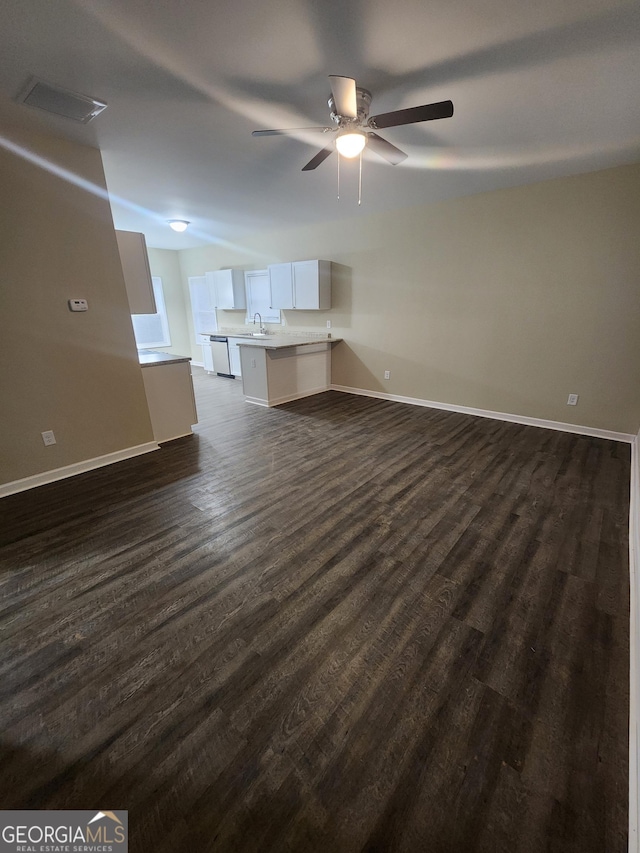 unfurnished living room with dark wood-type flooring, sink, and ceiling fan