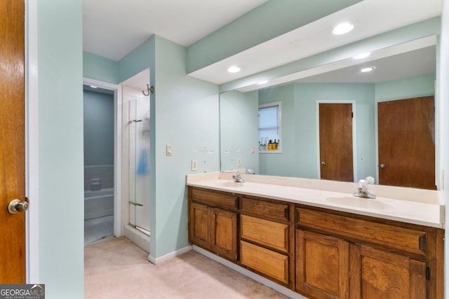 bathroom featuring vanity and a shower with door