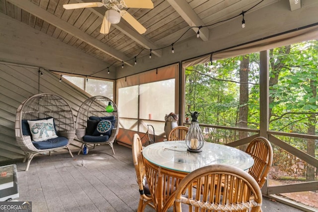 sunroom featuring ceiling fan, wooden ceiling, and vaulted ceiling with beams