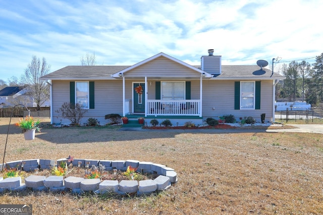 single story home featuring covered porch and a front lawn