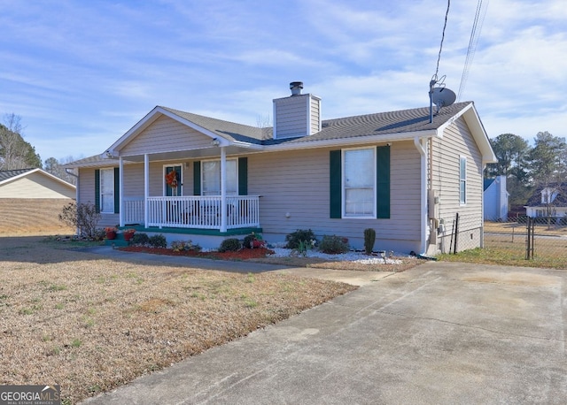 ranch-style house with a porch and a front lawn