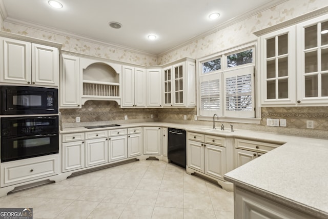 kitchen featuring white cabinetry, sink, and black appliances