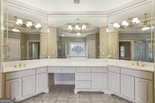 bathroom with tile patterned flooring, ornamental molding, vanity, and an inviting chandelier