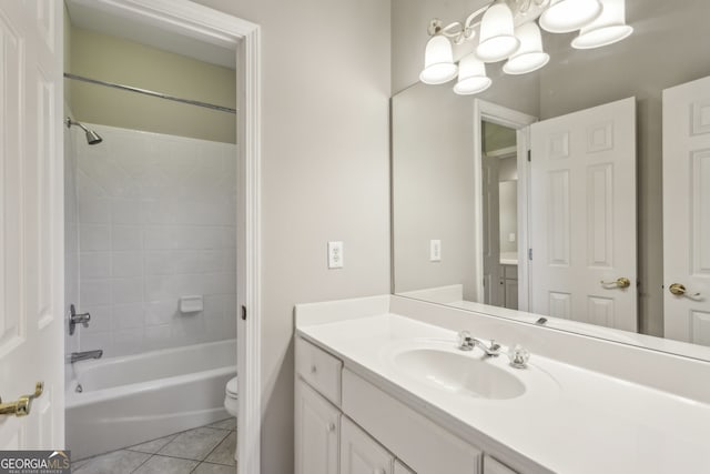 full bathroom with vanity, toilet, tiled shower / bath combo, and tile patterned flooring