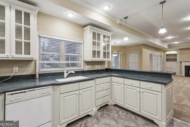 kitchen featuring sink, dishwasher, ornamental molding, white cabinets, and decorative light fixtures