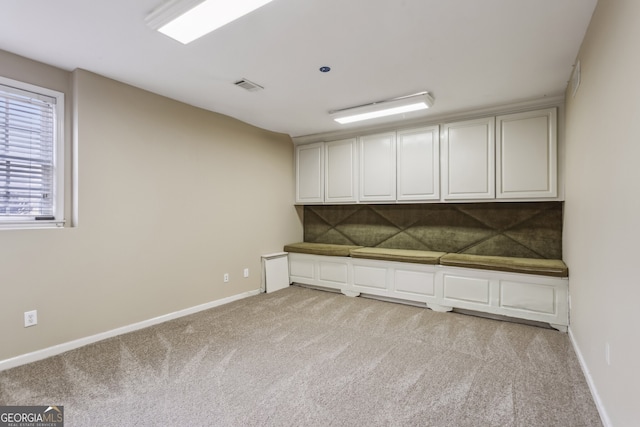 interior space featuring light colored carpet